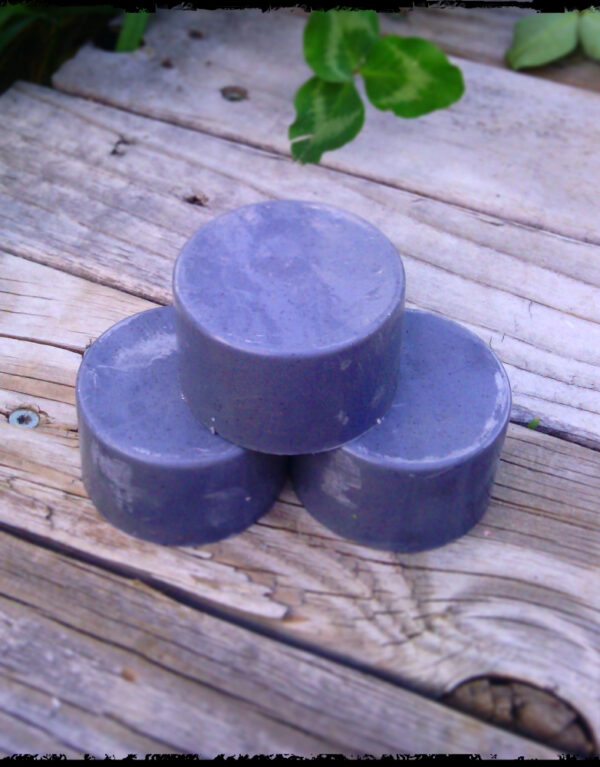 Three round grey bars of soap.