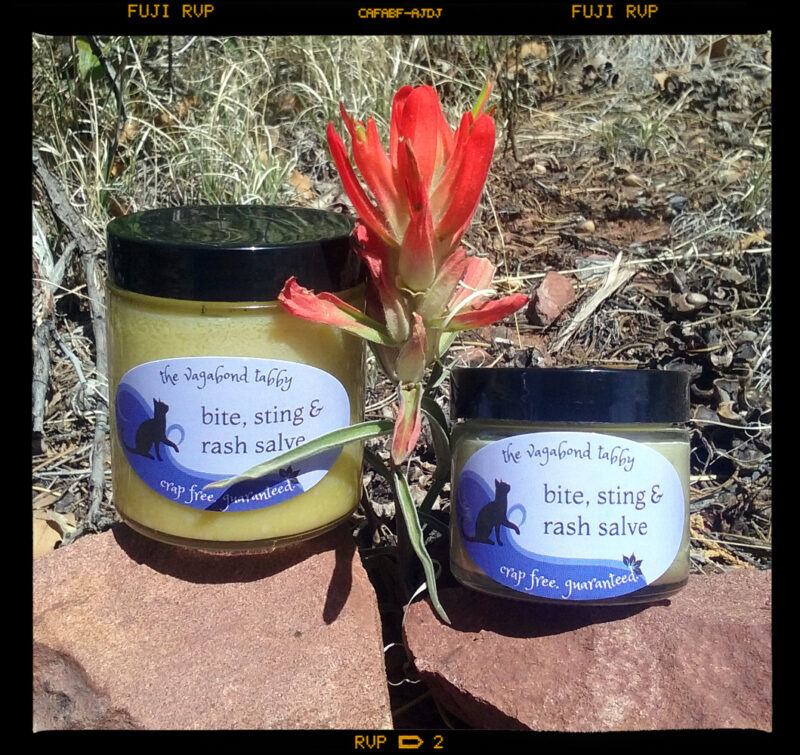 Two clear glass jars of pale yellow salve, one bigger than the other.