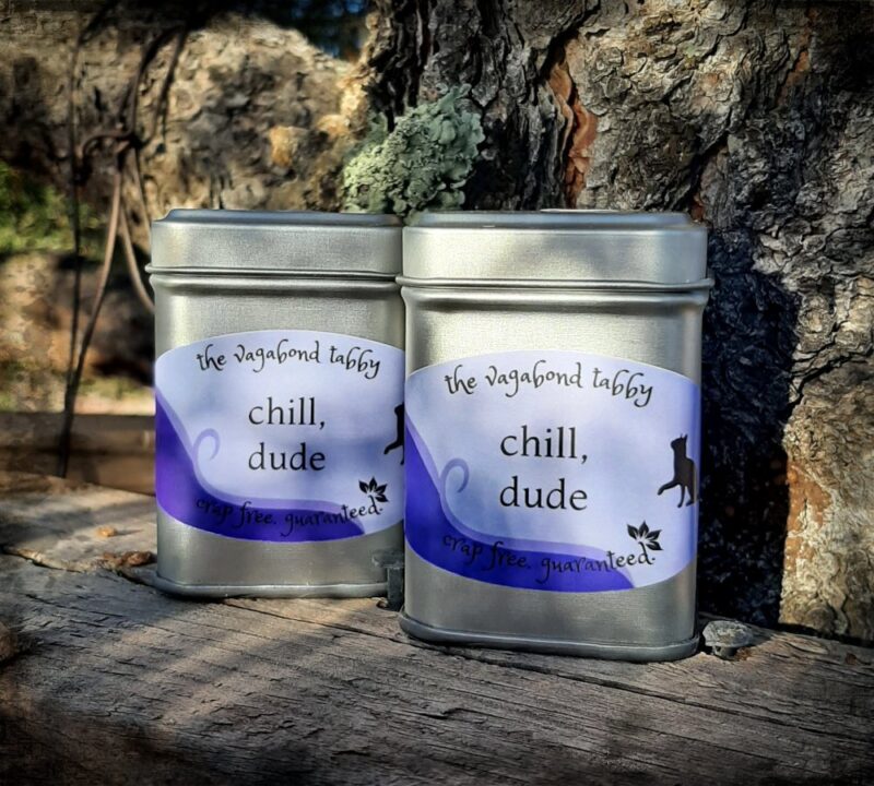 Two stainless steel tea tins; the labels say "chill, dude".