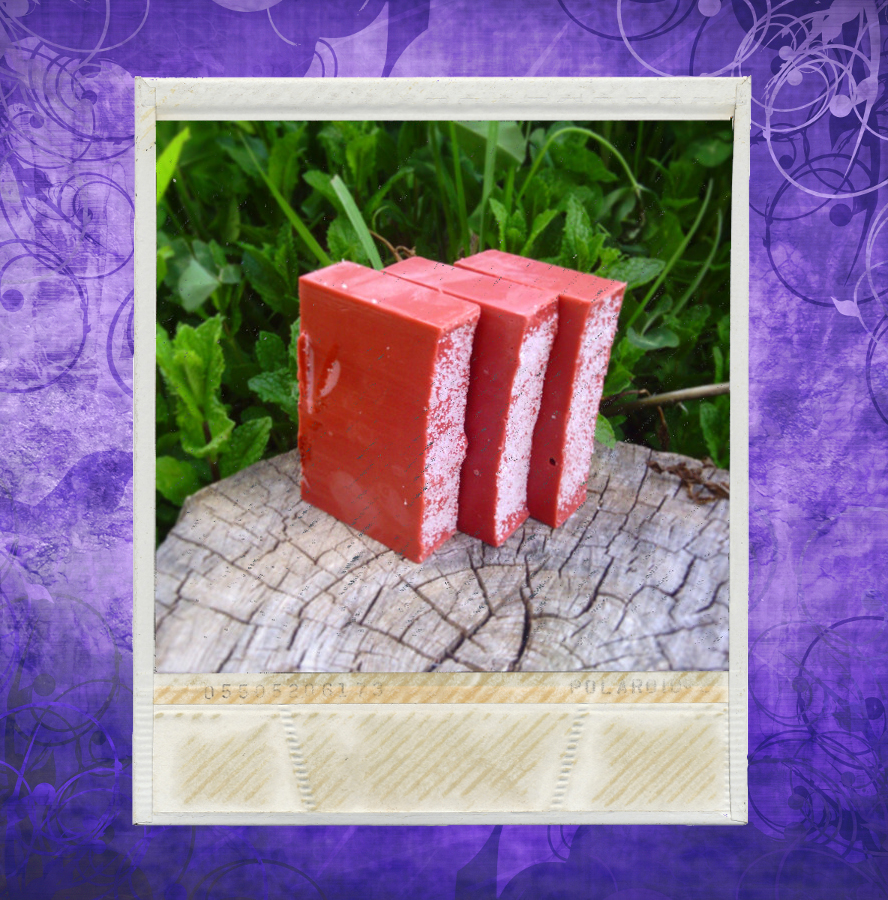 Three bars of red soap, with white sea salt sprinkled on top.