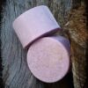 Two round bars of pink soap.