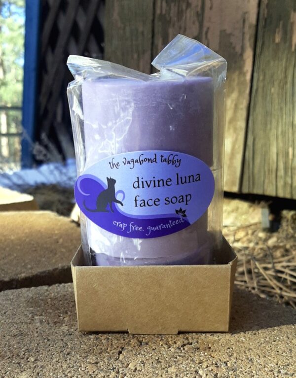 Three round bars of pink soap encased in compostable plastic. The label says "divine luna face soap".