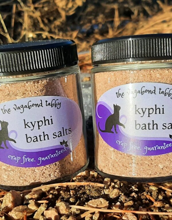Two clear glass jars filled with brown bath salts.
