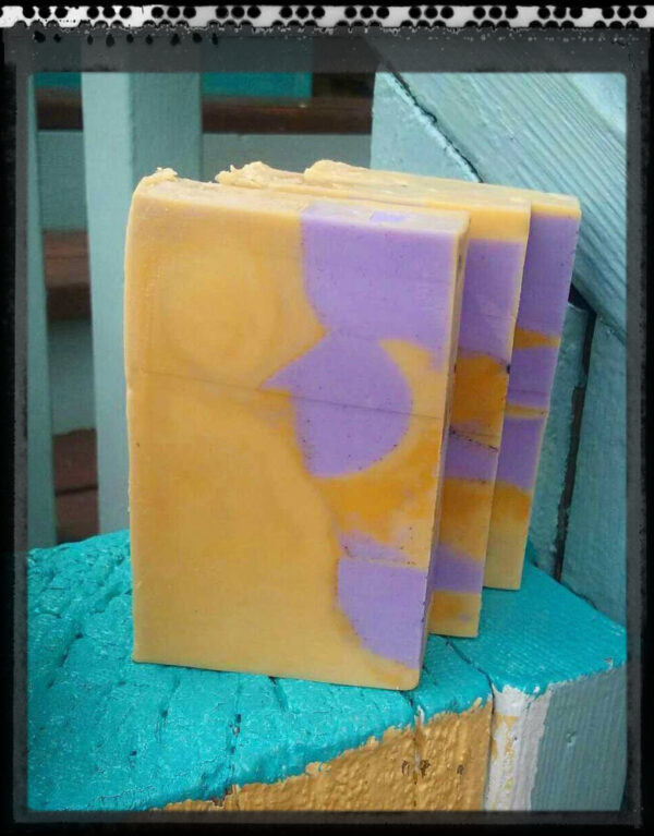 Three bars of soap, yellow with purple cubes and spheres embedded in them.