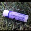 A white lip balm tube; the label says 'lavender lemonade'.