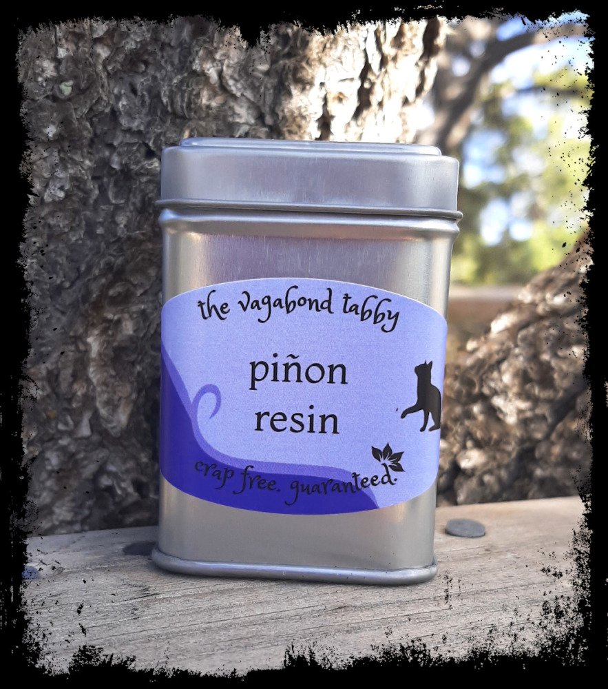 A stainless steel tin; the label says 'pinyon resin'.