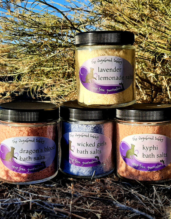 Four jars of bath salts, in four different colors.