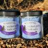 Two clear glass jars filled with blue bath salts, labeled "wicked girls saving ourselves".