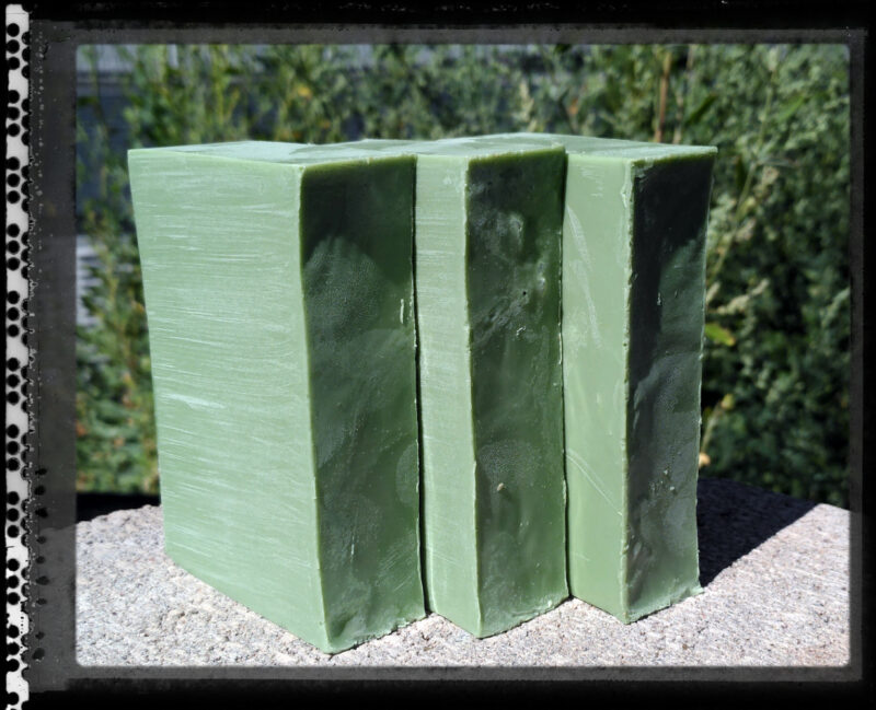 Three bars of yellowish-green soap.