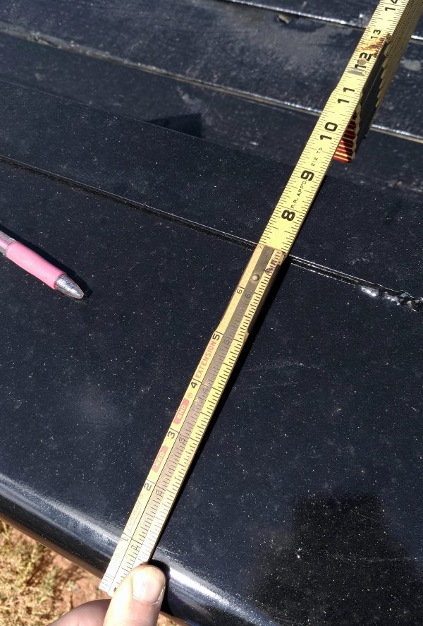 The foldable ruler has been unfolded a bit, out to twelve inches, to measure the thing over the tires, which is nine inches wide.