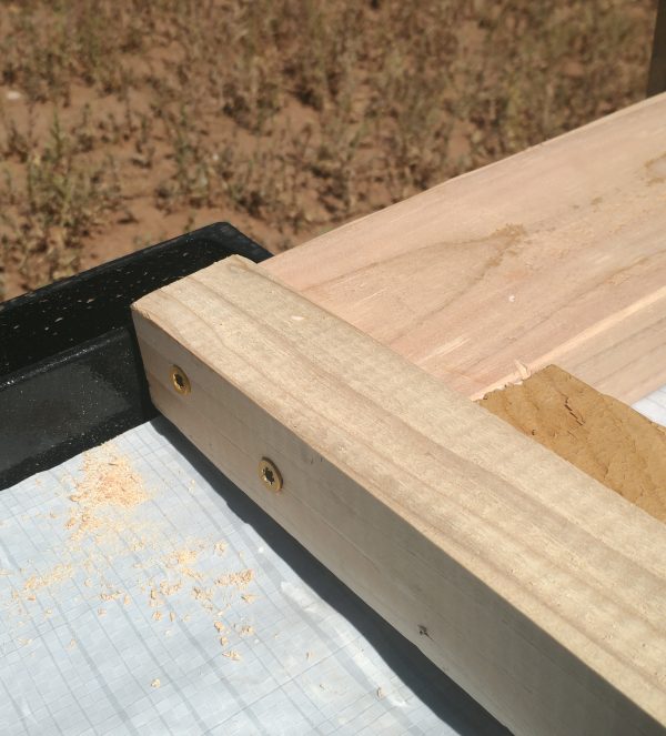 Three pieces of wood nicely dovetailed together & held in place with wood screws.