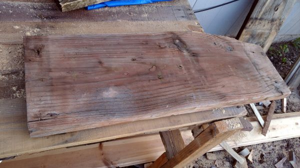 A thick, sturdy, somewhat weatherworn slab of wood, sitting on my worktable.