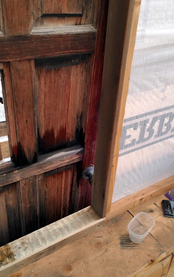 The bottom right corner of the door hole, which now has a nice doorframe made of reclaimed wood.