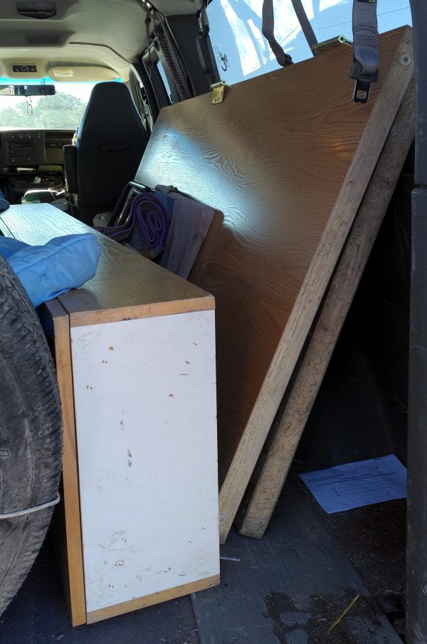 The back of my van, into which has been stuffed two VERY LARGE wood doors & a wood cabinet.