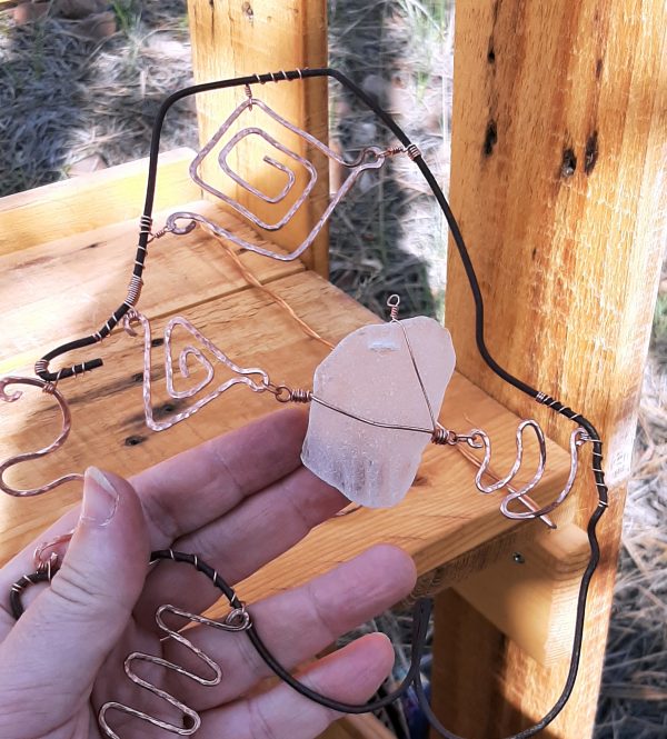 Yes, my finger is holding the seaglass piece in place, but also I've made another loop at the top of it with thinner wire, which will hold it right once I've attached that to something else.