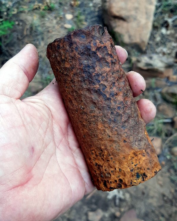 A short bit of iron pipe, well pitted & rusted. It's perhaps five inches long & maybe an inch & a half across.