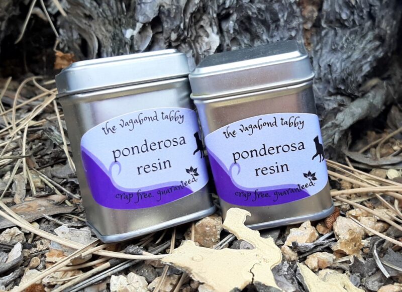 Two stainless steel tins; the label on each says 'ponderosa resin'.