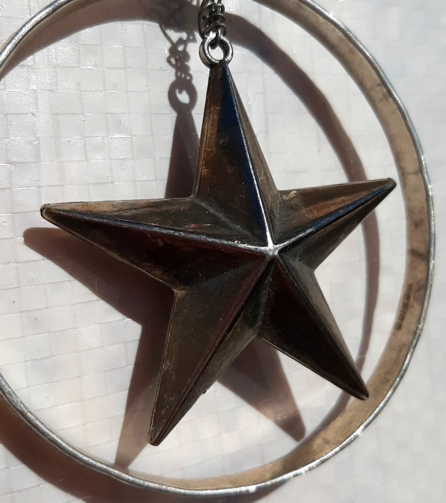 A closer view of the star, which is firmly three-dimensional, thicker at the center, tapering to the points.