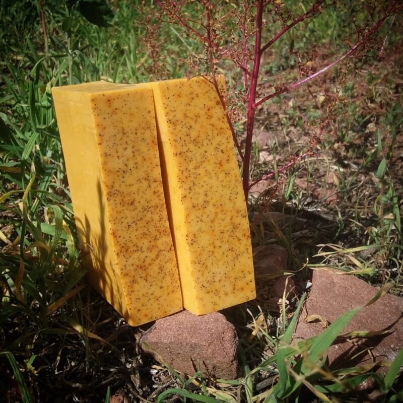 Two bars of faintly speckled orange soap.