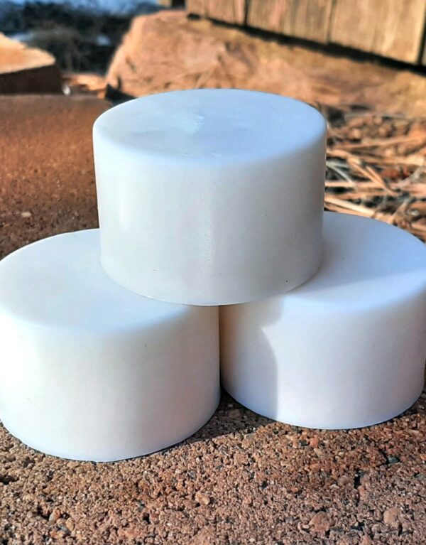 Three round bars of white soap.