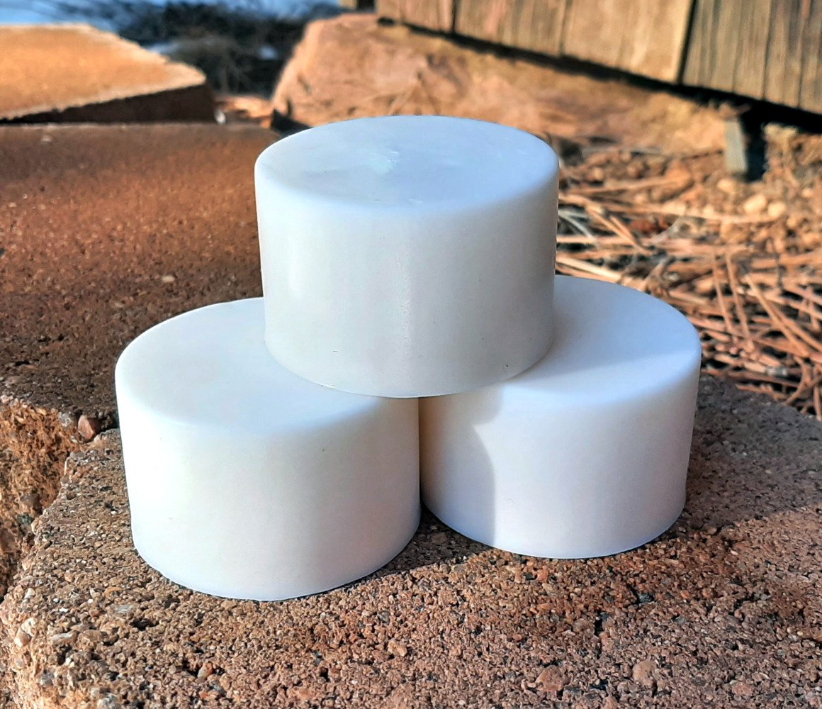 Three round bars of white soap.