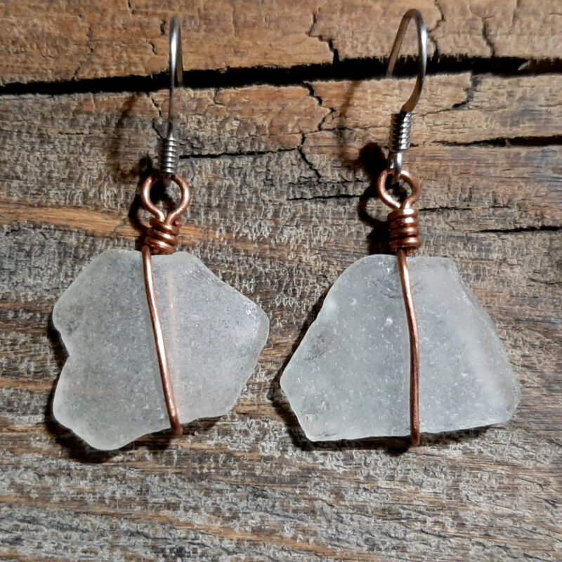 Each earring is a piece of white creek glass, simply wrapped in copper wire.