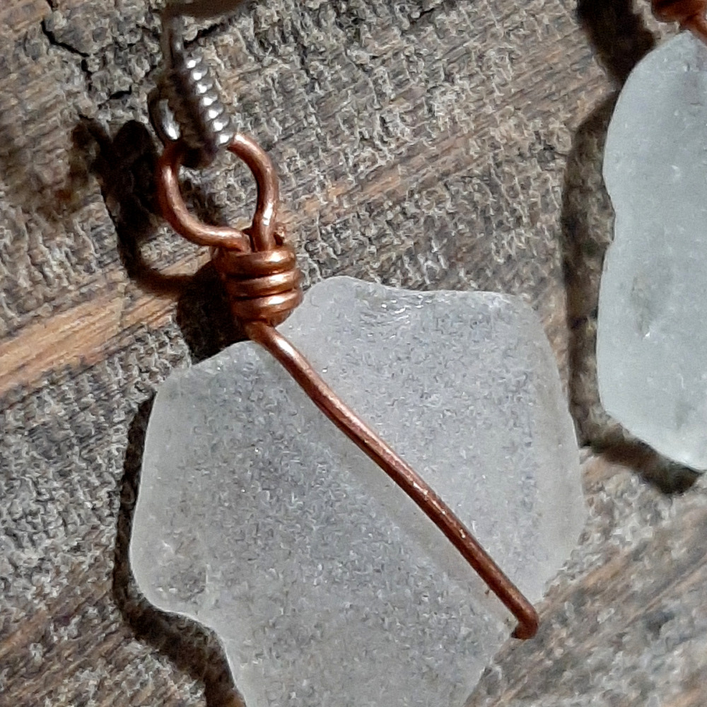 Each earring is a piece of white creek glass, simply wrapped in copper wire.